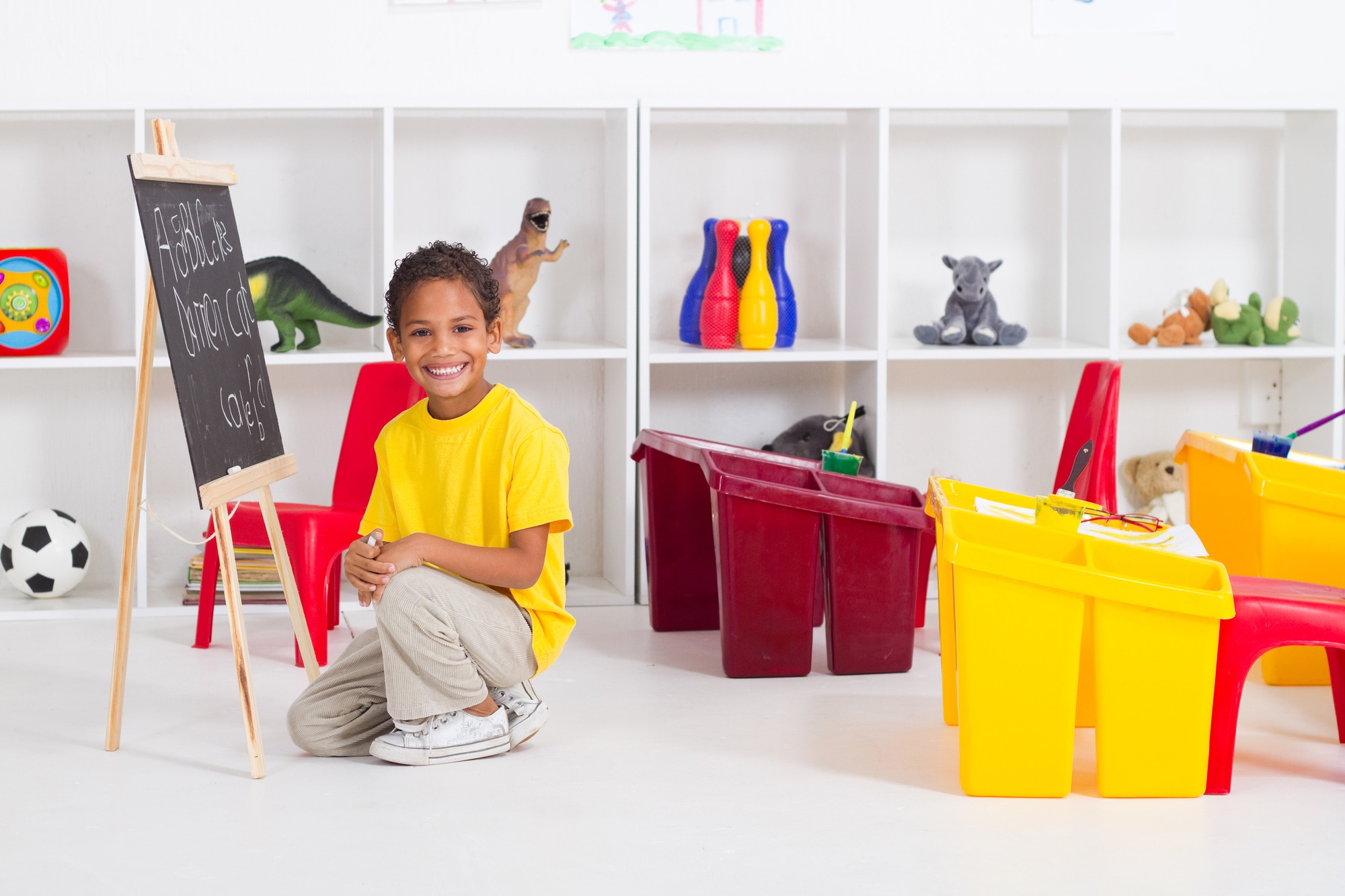 portrait of a happy indian kindergarten boy in classroom