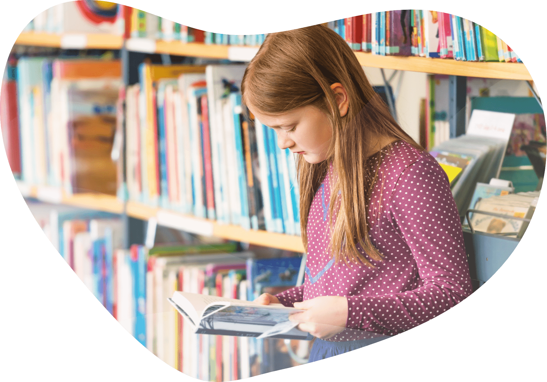 A girl sits in a library
